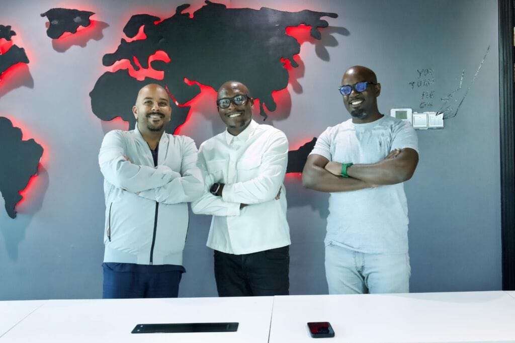 Julius Kyazze posing for a photo with NRG management